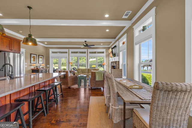 dining area with dark wood-style floors, ceiling fan, beam ceiling, and recessed lighting