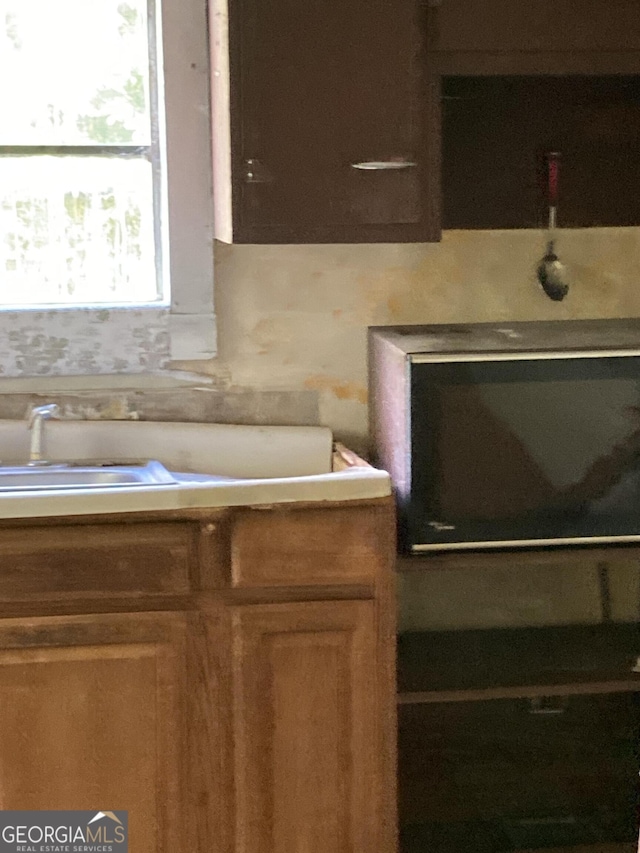 12196 Linton Rd S, Sparta, GA 31087 - kitchen featuring a sink and brown cabinets