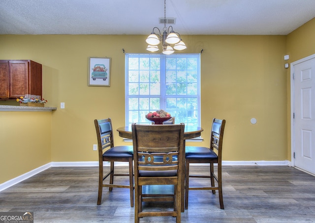 2326 Nicole Dr, Hampton, GA 30228 - dining room featuring a chandelier, dark wood-style floors, and baseboards
