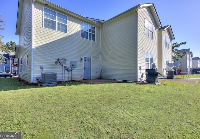 2326 Nicole Dr, Hampton, GA 30228 - back of property featuring central AC unit, a lawn, and a patio area