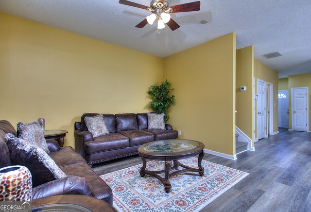 2326 Nicole Dr, Hampton, GA 30228 - living area featuring ceiling fan, wood finished floors, baseboards, stairway, and a textured ceiling