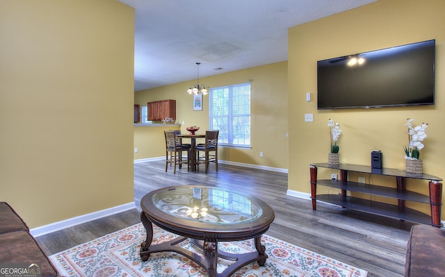 2326 Nicole Dr, Hampton, GA 30228 - living room featuring a chandelier, wood finished floors, and baseboards