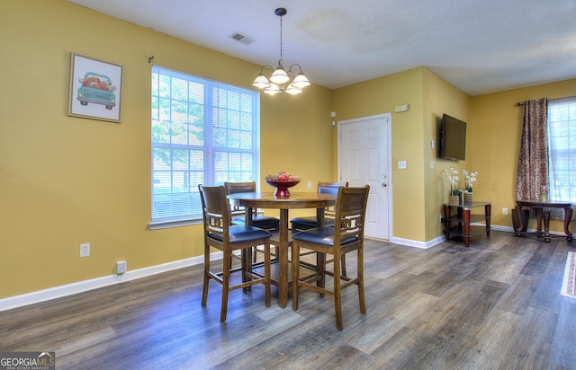 2326 Nicole Dr, Hampton, GA 30228 - dining area featuring dark wood finished floors, a chandelier, baseboards, and a textured ceiling
