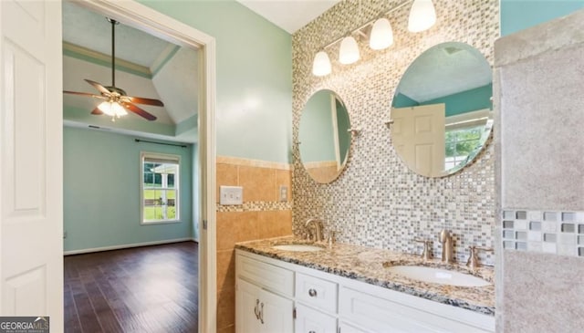 bathroom featuring wood finished floors, a ceiling fan, and double vanity
