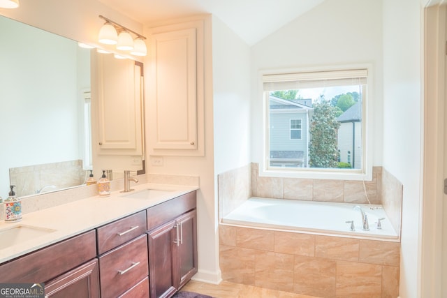 4448 Tacoma Trce, Suwanee, GA 30024 - bathroom featuring a garden tub, double vanity, and vaulted ceiling