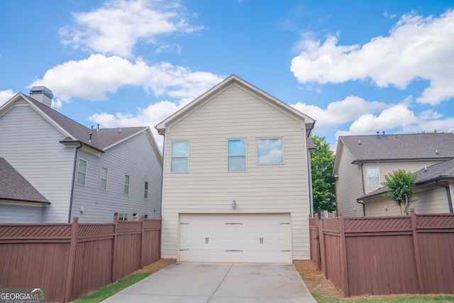4448 Tacoma Trce, Suwanee, GA 30024 - rear view of house with a garage and driveway