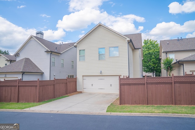 4448 Tacoma Trce, Suwanee, GA 30024 - back of house with an attached garage and concrete driveway