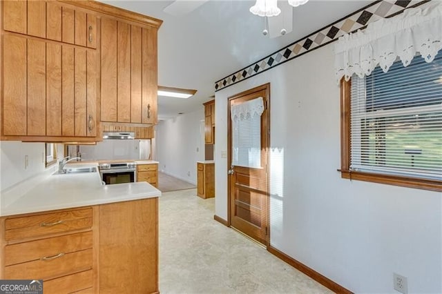 1471 Robinhood Trl, Gainesville, GA 30501 - kitchen featuring oven, under cabinet range hood, light countertops, brown cabinetry, and a peninsula
