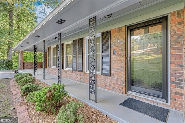 1471 Robinhood Trl, Gainesville, GA 30501 - view of exterior entry with a porch and brick siding