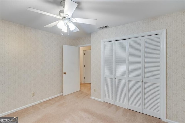 1471 Robinhood Trl, Gainesville, GA 30501 - unfurnished bedroom with carpet, a closet, a ceiling fan, wallpapered walls, and baseboards