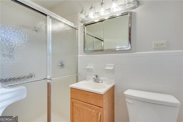 1471 Robinhood Trl, Gainesville, GA 30501 - bathroom with a stall shower, tile walls, toilet, wainscoting, and vanity