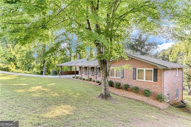 1471 Robinhood Trl, Gainesville, GA 30501 - view of front of property with brick siding, a front lawn, an attached carport, and driveway