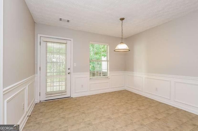 2838 Vining Ridge Ter Unit 0, Decatur, GA 30034 - unfurnished dining area featuring a wainscoted wall, a decorative wall, and a textured ceiling