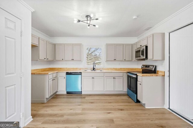 77 Frances St, Summerville, GA 30747 - kitchen with stainless steel appliances, a sink, light countertops, a chandelier, and ornamental molding