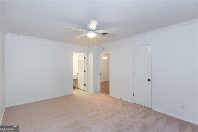 unfurnished bedroom with ornamental molding, light carpet, and baseboards