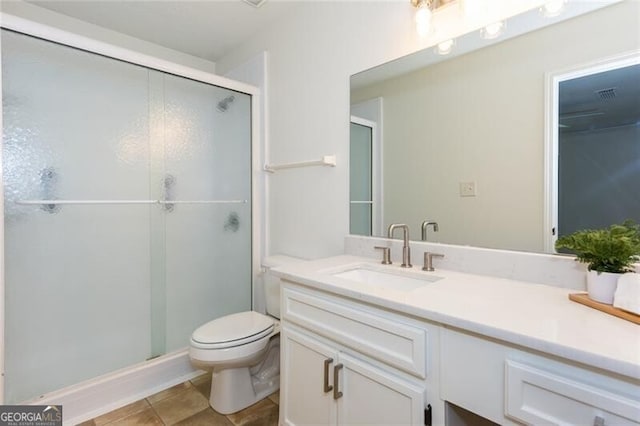 full bathroom featuring a shower stall, vanity, and toilet