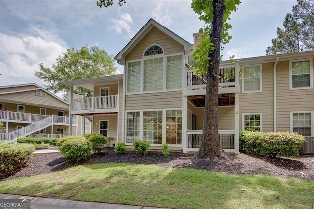 rear view of property featuring a lawn