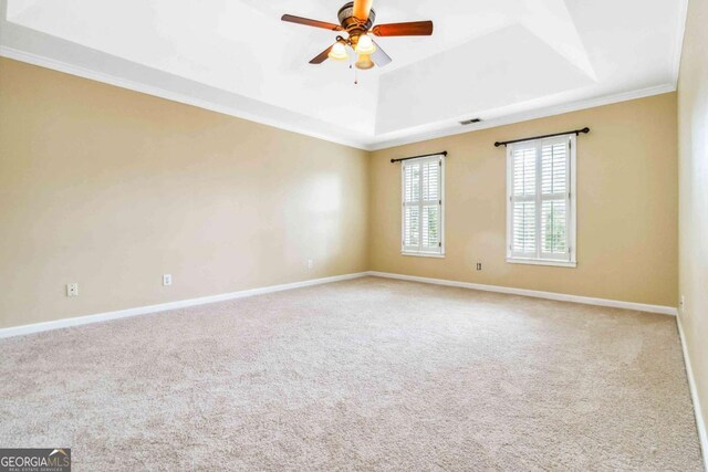 4002 Turnstone Dr NW, Kennesaw, GA 30152 - carpeted spare room featuring a tray ceiling, ornamental molding, ceiling fan, and baseboards