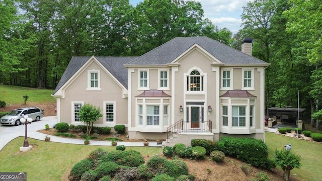 4002 Turnstone Dr NW, Kennesaw, GA 30152 - view of front of home featuring stucco siding, a chimney, and a front yard