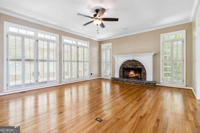 4002 Turnstone Dr NW, Kennesaw, GA 30152 - unfurnished living room featuring ceiling fan, wood finished floors, baseboards, ornamental molding, and a stone fireplace