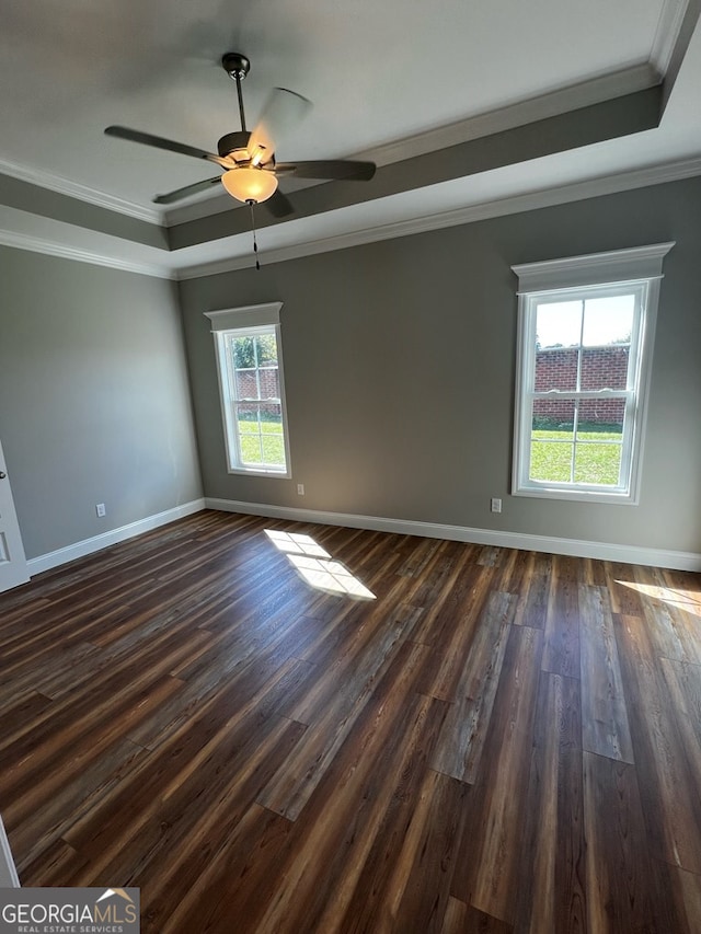 1005 Syrup Mill Creek Ln, Cairo, GA 39828 - empty room featuring a raised ceiling, dark wood-style flooring, baseboards, ornamental molding, and a ceiling fan