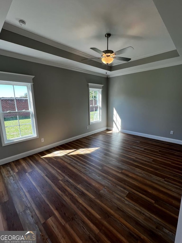1005 Syrup Mill Creek Ln, Cairo, GA 39828 - empty room with a raised ceiling, baseboards, ornamental molding, dark wood-style floors, and a ceiling fan