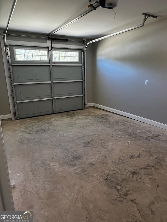 1005 Syrup Mill Creek Ln, Cairo, GA 39828 - garage featuring baseboards and a garage door opener