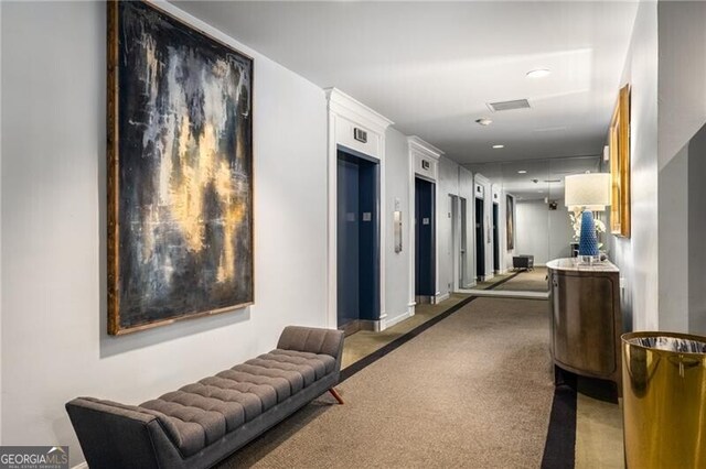 1421 Peachtree St NE Unit 203, Atlanta, GA 30309 - corridor with elevator, baseboards, and carpet flooring