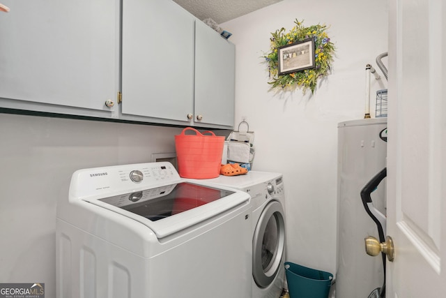 139 Heath Dr S, Macon, GA 31220 - laundry area with washing machine and clothes dryer, cabinet space, water heater, and a textured ceiling