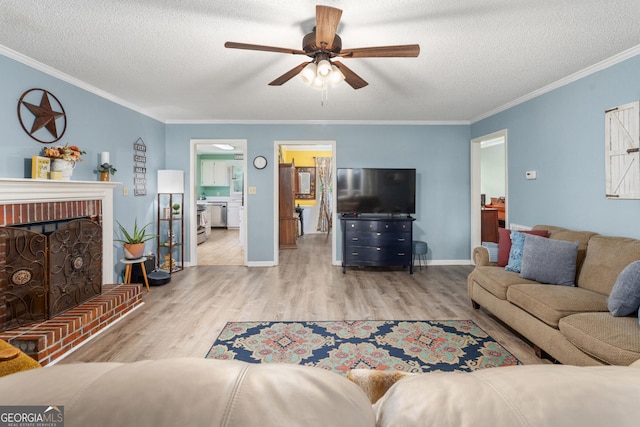 139 Heath Dr S, Macon, GA 31220 - living area with ceiling fan, wood finished floors, a textured ceiling, crown molding, and a fireplace