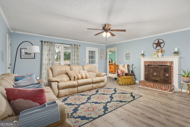 139 Heath Dr S, Macon, GA 31220 - living room with a ceiling fan, ornamental molding, wood finished floors, a textured ceiling, and a brick fireplace