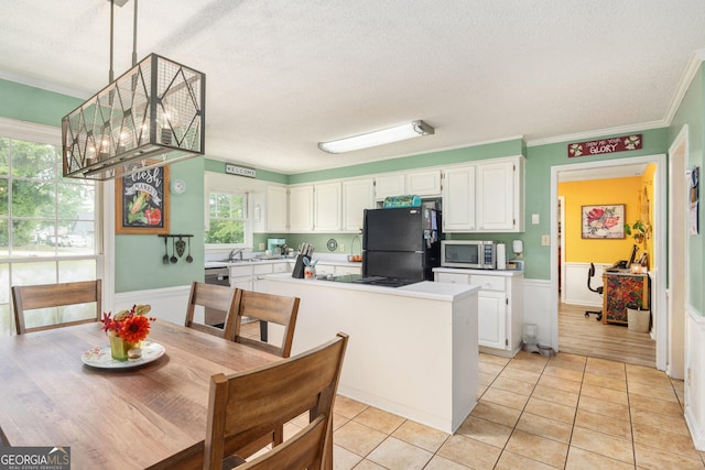 139 Heath Dr S, Macon, GA 31220 - kitchen featuring black appliances, white cabinetry, a textured ceiling, light countertops, and crown molding