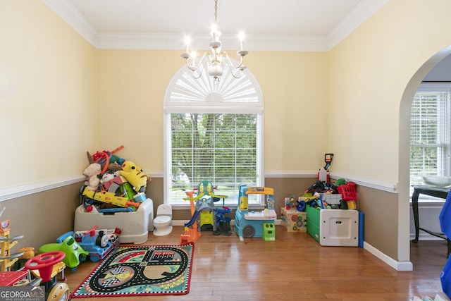 11 Vintage Ct SW, Cartersville, GA 30120 - rec room featuring arched walkways, a chandelier, crown molding, and wood finished floors
