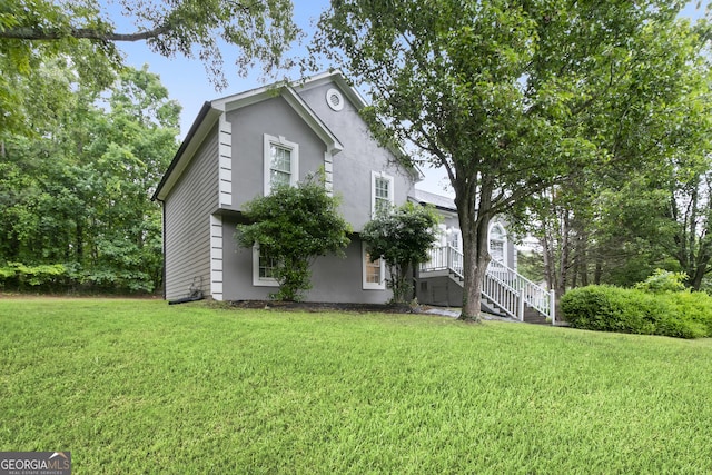 11 Vintage Ct SW, Cartersville, GA 30120 - view of side of home featuring stucco siding and a lawn