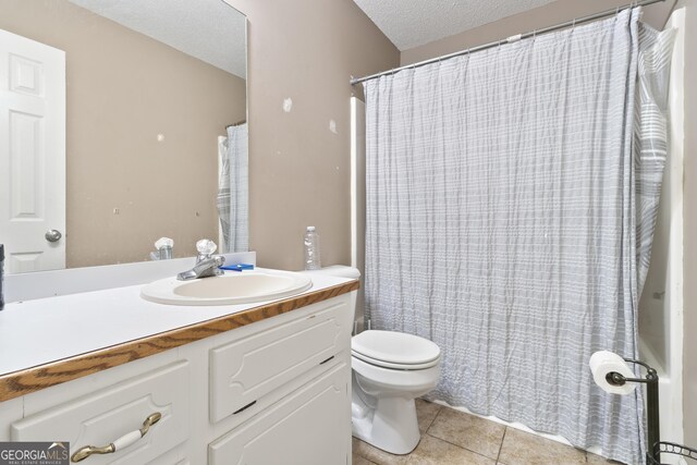 11 Vintage Ct SW, Cartersville, GA 30120 - full bathroom with tile patterned flooring, toilet, a textured ceiling, vanity, and a shower with shower curtain