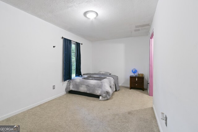 11 Vintage Ct SW, Cartersville, GA 30120 - carpeted bedroom featuring a textured ceiling and baseboards