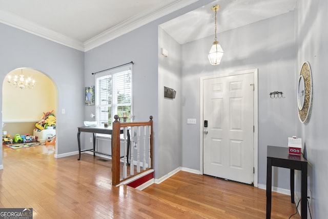 11 Vintage Ct SW, Cartersville, GA 30120 - foyer with wood finished floors, a chandelier, ornamental molding, baseboards, and arched walkways