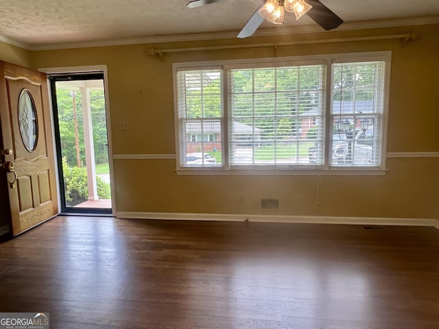 entryway with baseboards, ceiling fan, ornamental molding, dark wood-style floors, and a textured ceiling