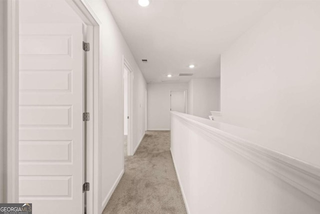 hall with light carpet, recessed lighting, and baseboards