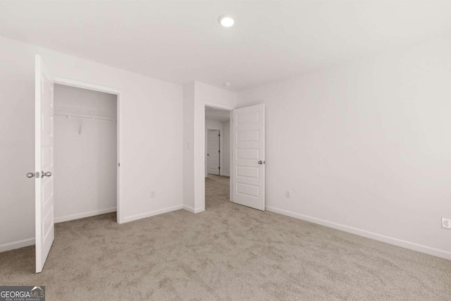 unfurnished bedroom with carpet flooring, baseboards, a closet, and recessed lighting