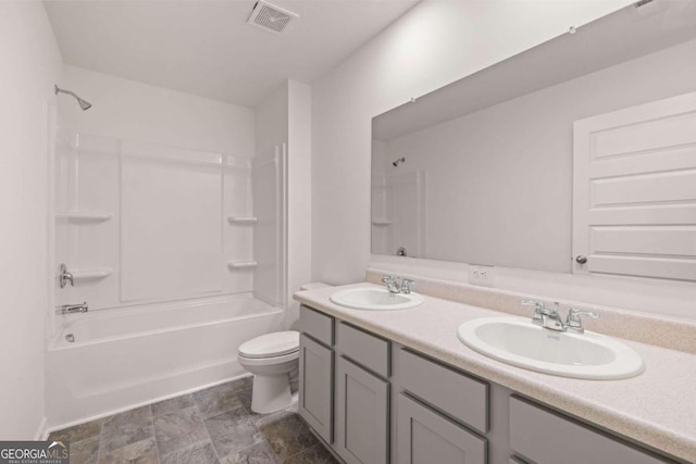 bathroom with shower / bath combination, toilet, and double vanity