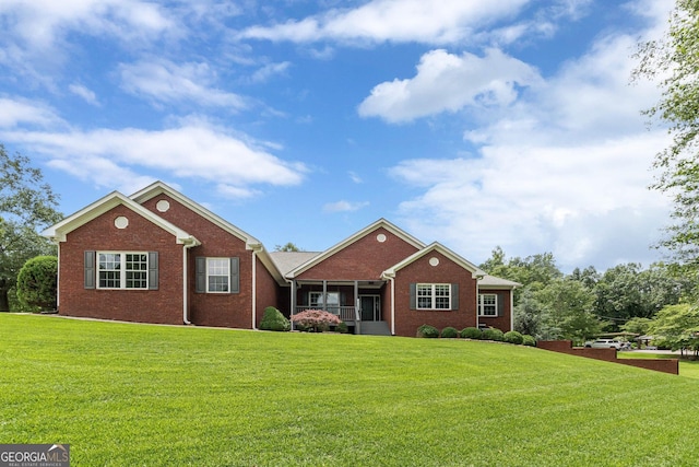 516 Main St, Hiram, GA 30141 - ranch-style house with brick siding, a front yard, and a sunroom