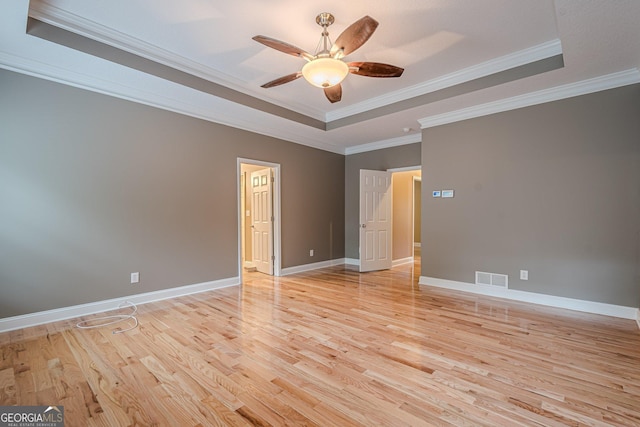 516 Main St, Hiram, GA 30141 - empty room featuring a raised ceiling, ceiling fan, light wood-type flooring, ornamental molding, and baseboards