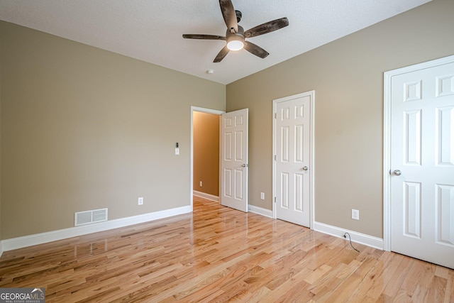 516 Main St, Hiram, GA 30141 - unfurnished bedroom with light wood-style flooring, baseboards, and ceiling fan