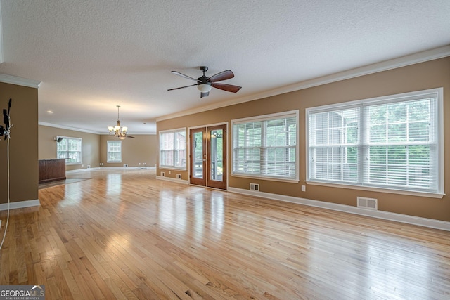516 Main St, Hiram, GA 30141 - unfurnished living room featuring crown molding, a chandelier, a textured ceiling, light wood-style flooring, and baseboards