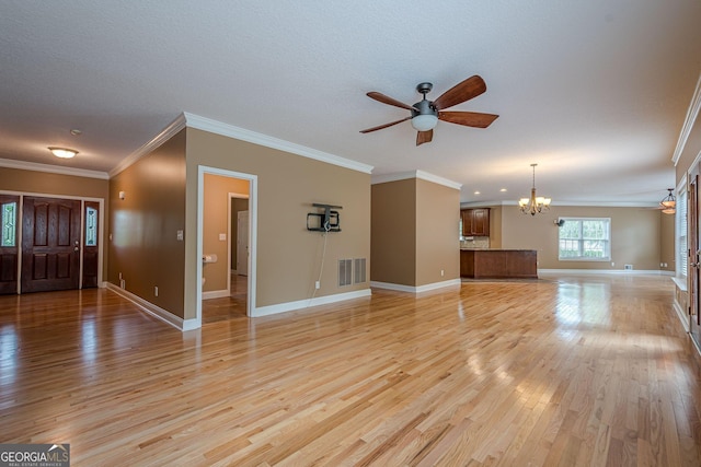 516 Main St, Hiram, GA 30141 - unfurnished living room featuring a chandelier, light wood-type flooring, ceiling fan, baseboards, and crown molding