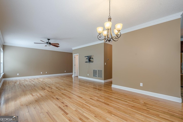 516 Main St, Hiram, GA 30141 - spare room with light wood finished floors, crown molding, ceiling fan, a chandelier, and baseboards