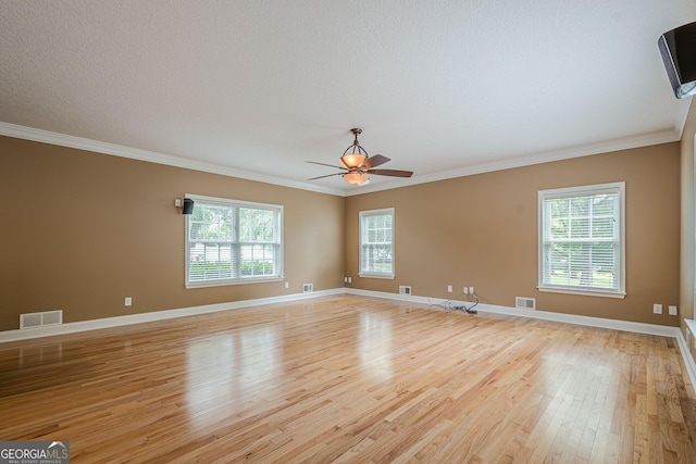 516 Main St, Hiram, GA 30141 - empty room featuring light wood finished floors, healthy amount of natural light, crown molding, a ceiling fan, and baseboards