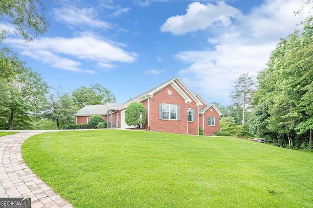 516 Main St, Hiram, GA 30141 - view of front of home with brick siding, a front lawn, and an attached garage