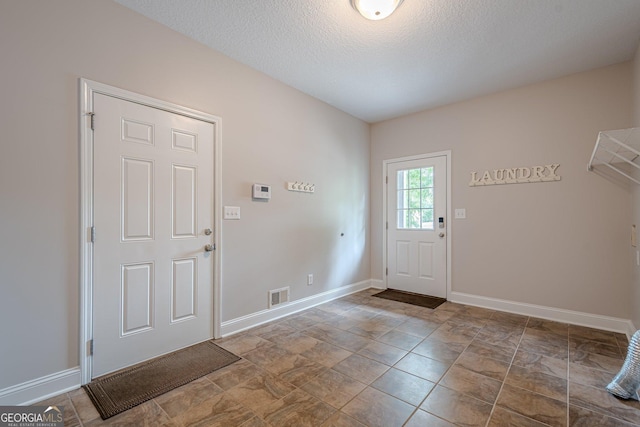 516 Main St, Hiram, GA 30141 - foyer featuring baseboards and a textured ceiling